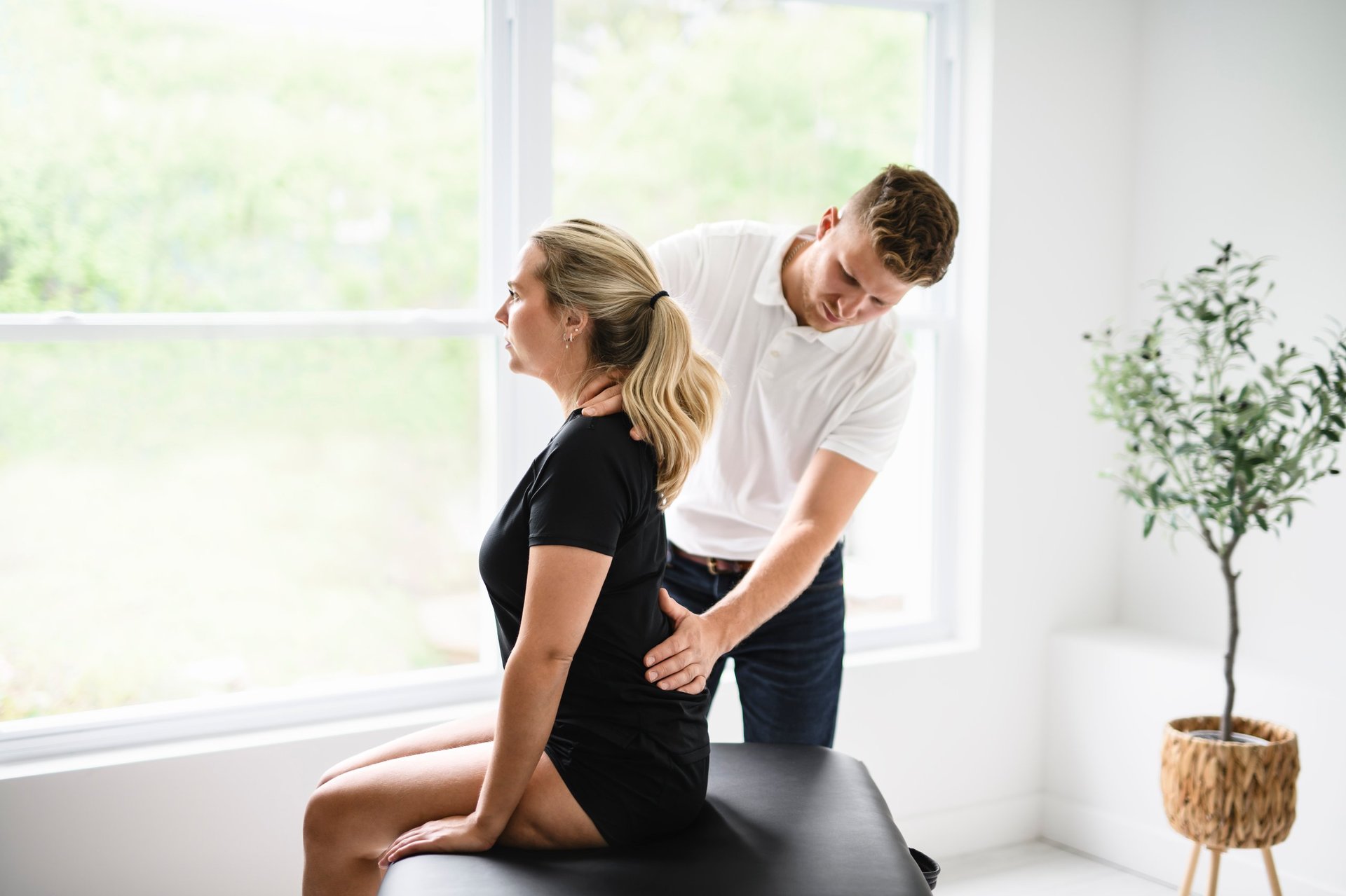 Male physio therapist and woman helping patient