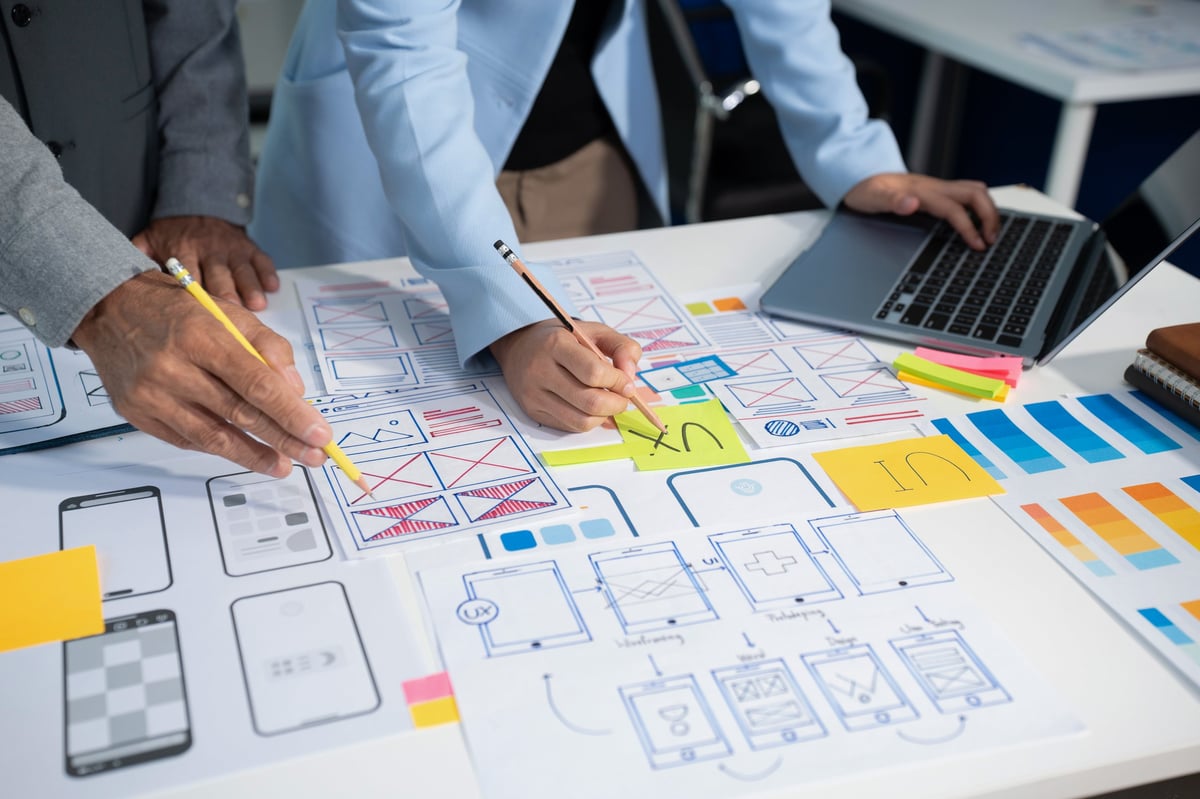 Creative digital development agency with developer team working on laptops and digital devices