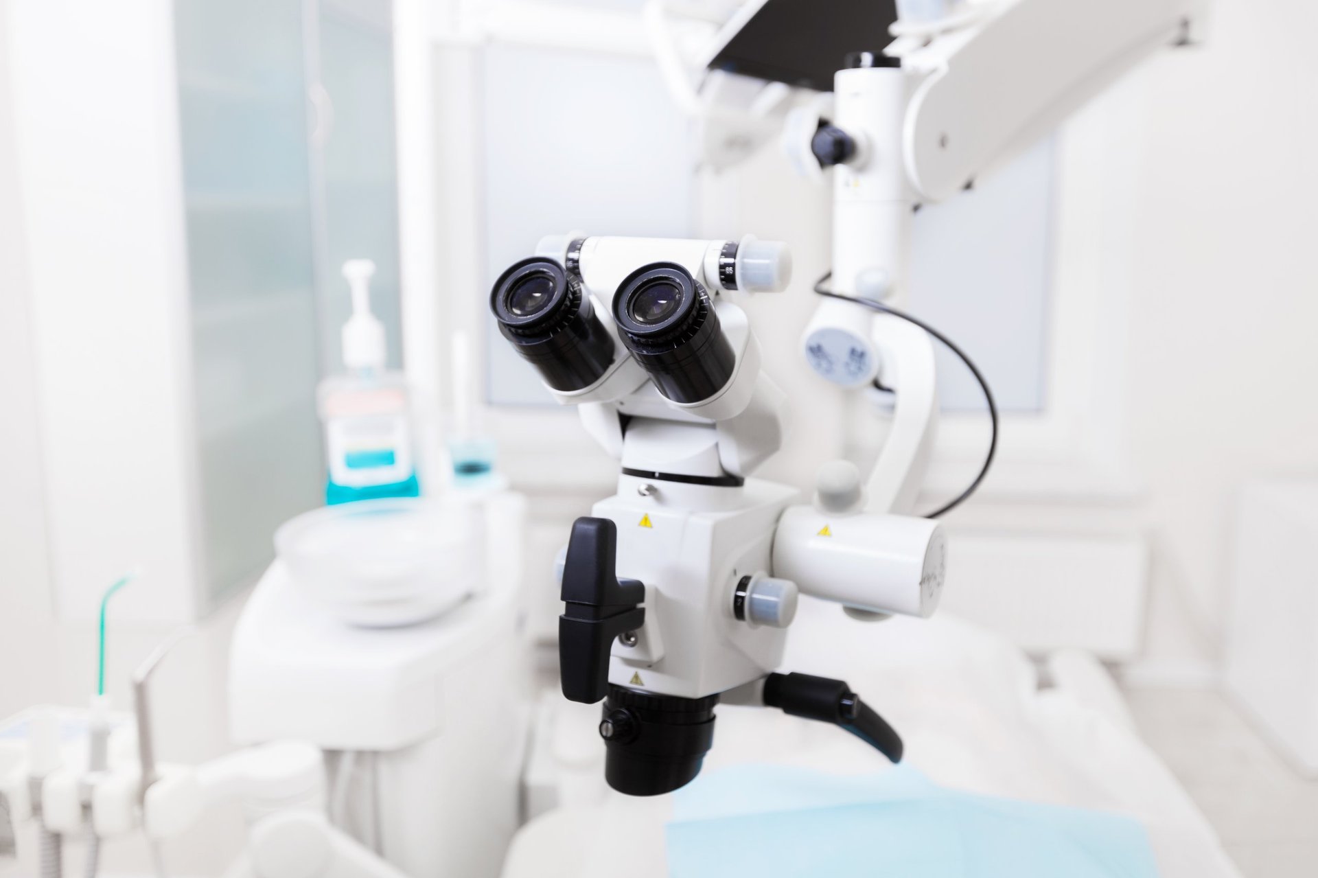 Professional dental endodontic binocular microscope in a modern dental treatment room